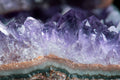 Amethyst raw crystal cluster close-up — deep purple points of the calm stone