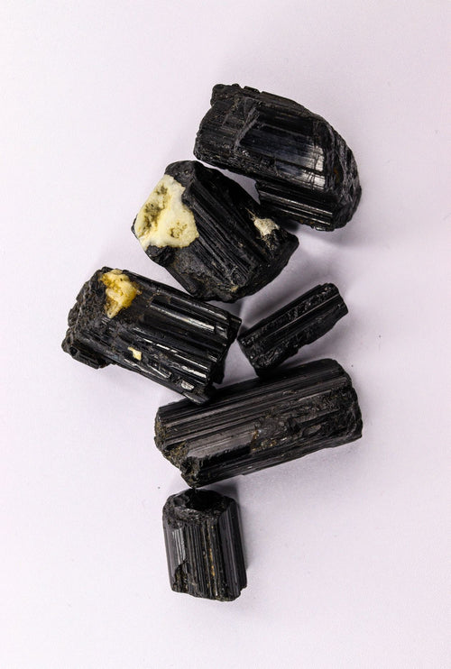 Black Tourmaline raw crystal pieces — striated columns of the protection stone