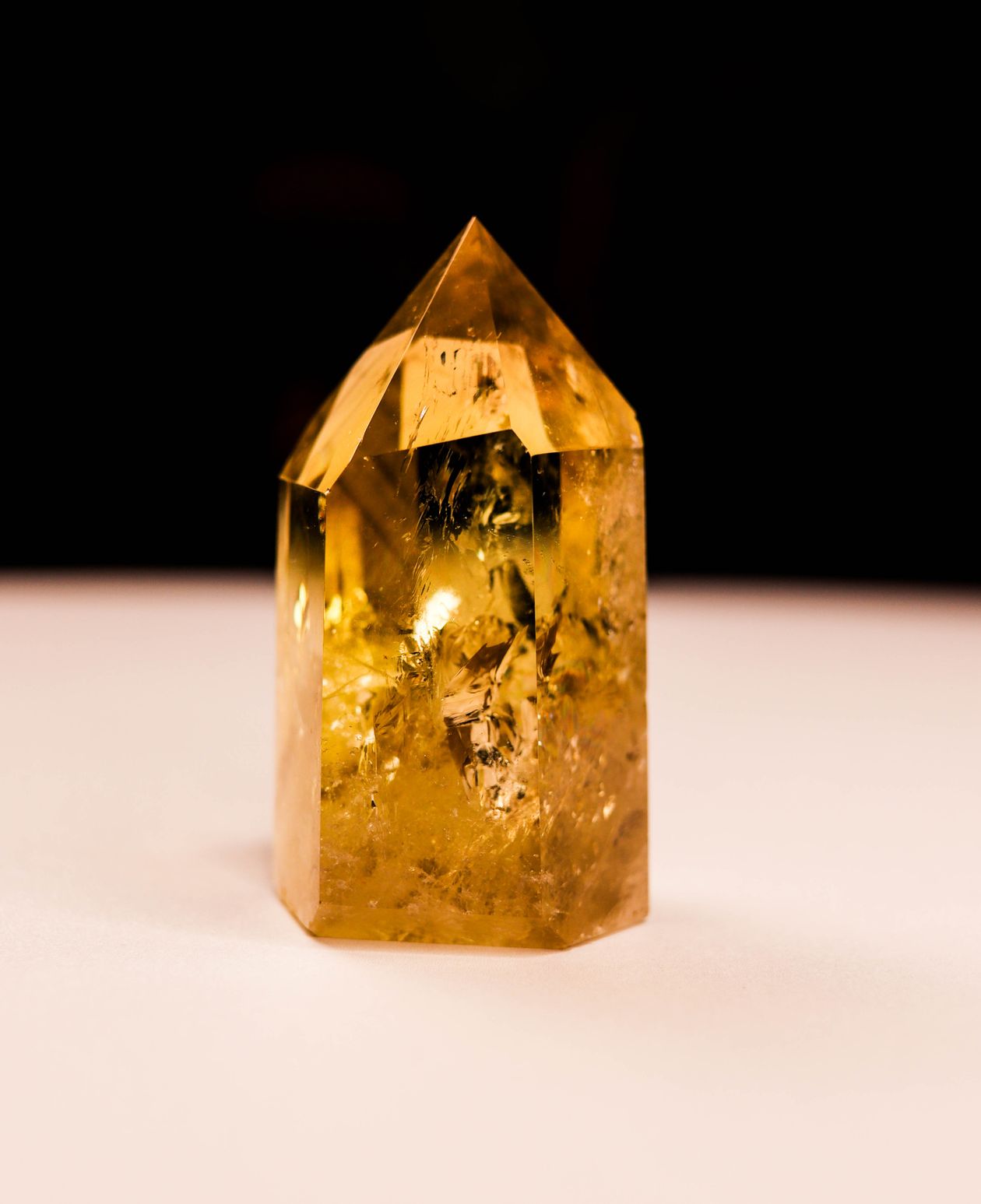 Citrine crystal tower glowing golden amber — abundance frequency stone